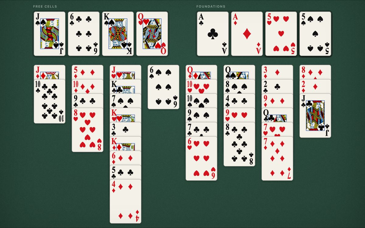 A FreeCell game in progress: four free cells at the top left, four foundations at the top right and eight columns of face-up cards on green felt